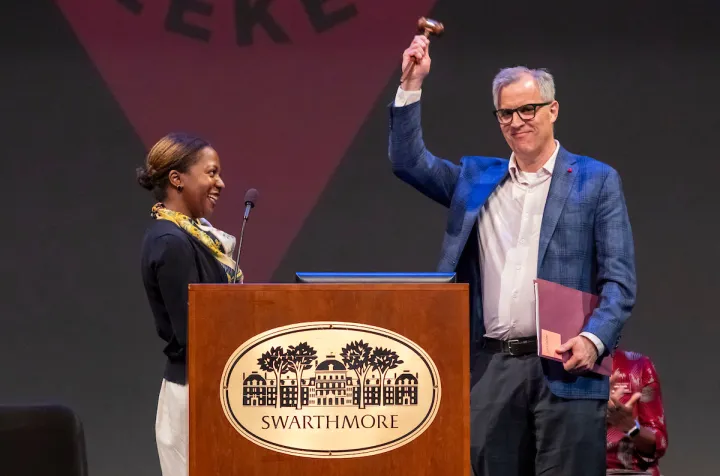 Man holds up gavel at Swarthmore podium