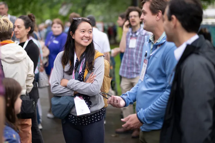 Alums smiling and having conversation