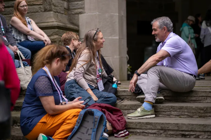 Alums sit on steps leading up to Clothier bell tower