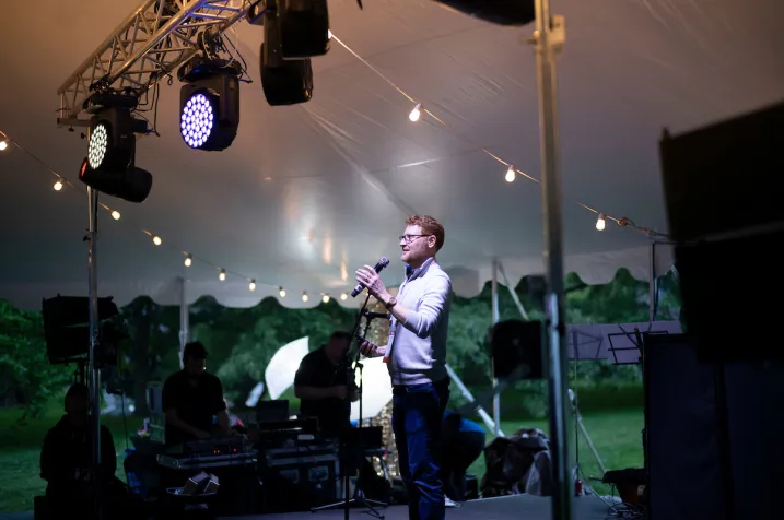 Person on stage under tent