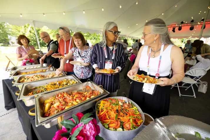Alumni get food at buffet