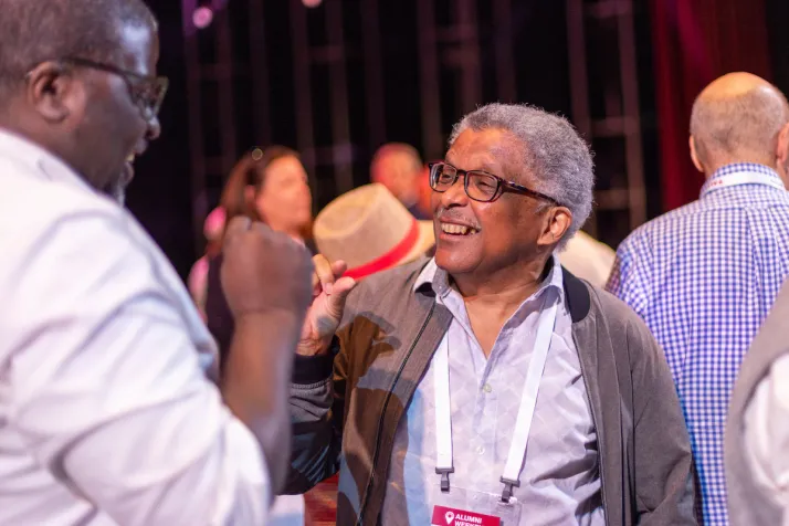 Alumni smile and have conversation