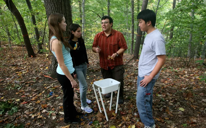 Instructor speaking to students in Crum Woods