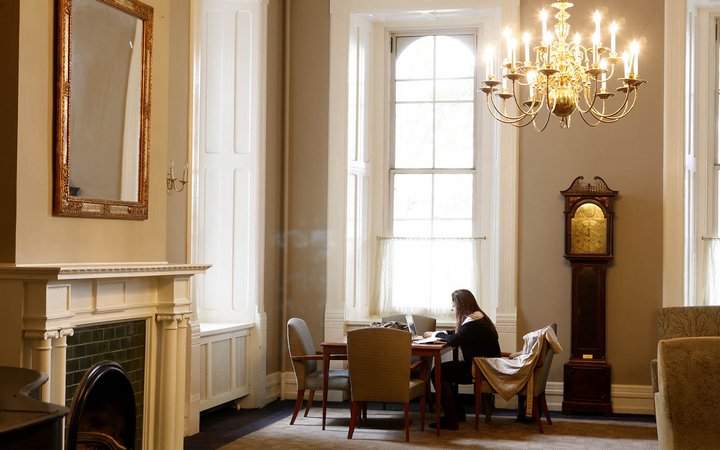 A student studying in Parrish Parlor