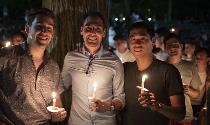 Students pose with candles at Last Collection
