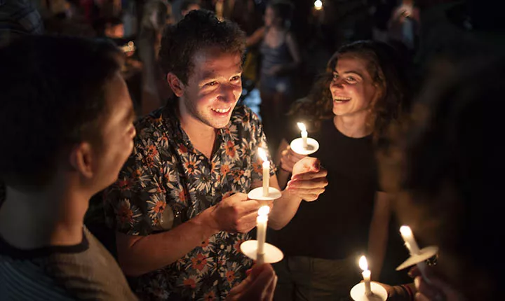 Students pose with candles at Last Collection