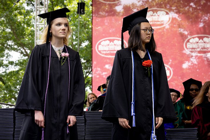 Ann Sinclair '23 and Erin Chen '23 stand on stage