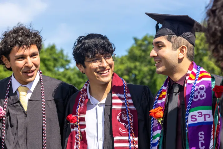 Group of students smiling before commencement ceremony