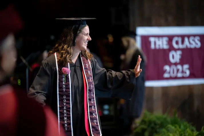 Student on stage waves to crowd