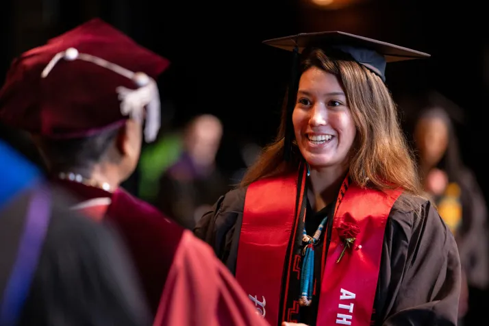Student receives diploma from Val Smith