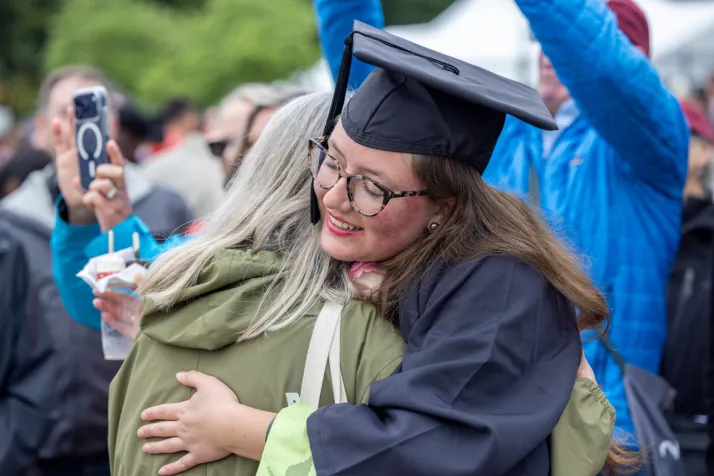 Student hugs supporter after graduation ceremony