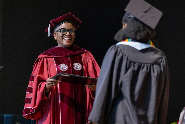 Val Smith with student at commencement