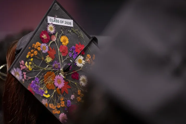 Back of mortarboard that reads "Class of 2026" with flowers adorning