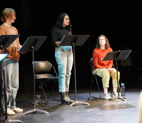 Arlo Strauss watches from the left as Kinjal Dave speaks. Rose Palmieri watches, seated, from the right. 