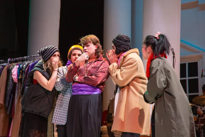JJ Peachum is surrounded by beggars as they think of what to do next