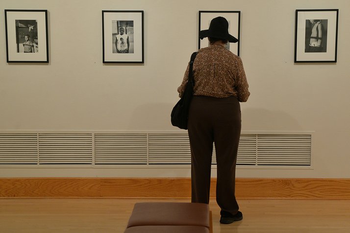 Woman views art in List gallery