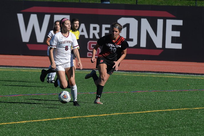 Two players compete on a soccer field