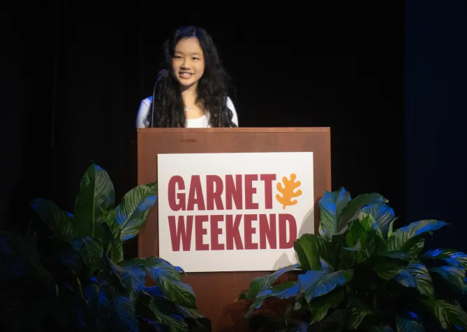 Student speaks at Garnet Weekend podium