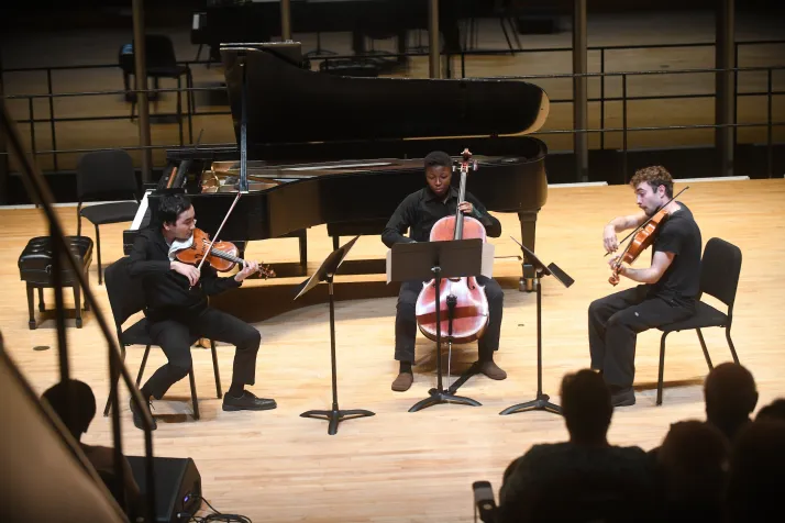 Trio on stage with cello, violin and viola