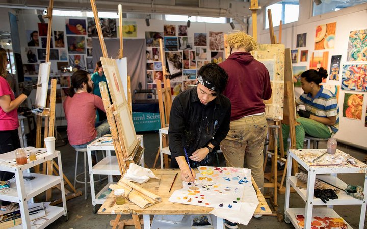 Student working on art in a studio
