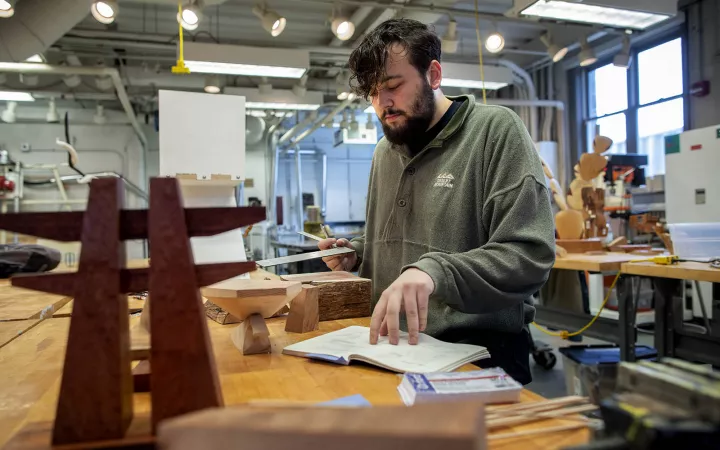 Student looking at notes while in art studio