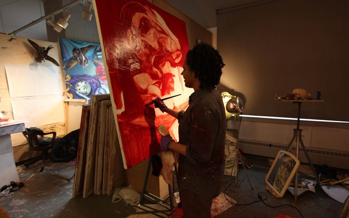 Student painting in a studio