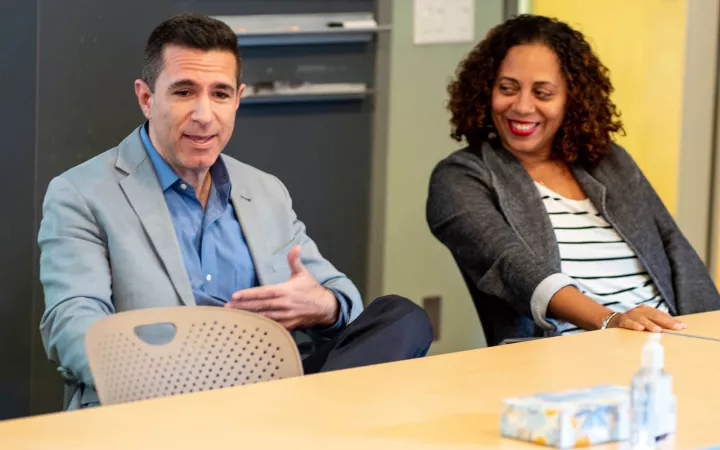 Two people sitting at table in the Lang Center