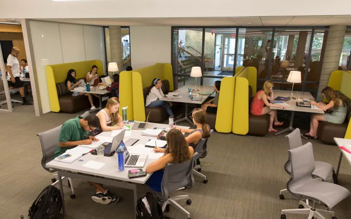 students sitting at tables in booths