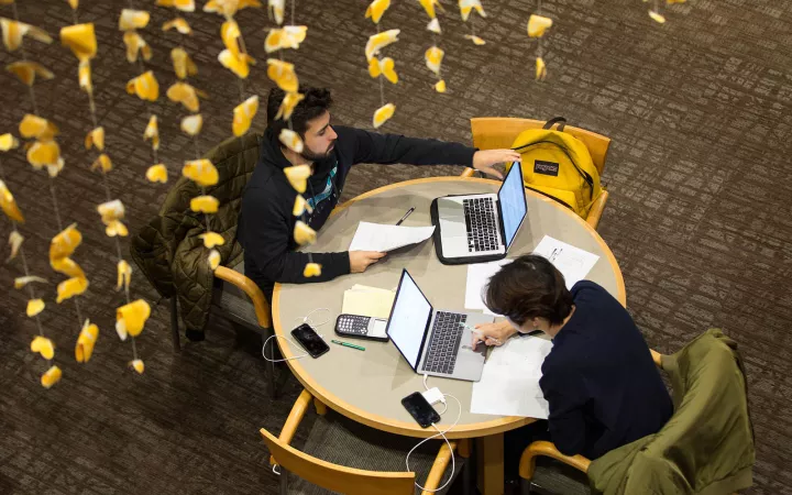 two students at round table from above