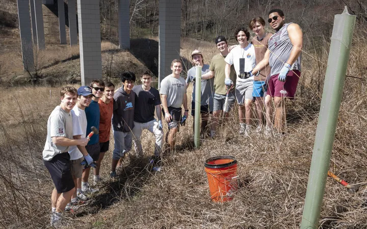 lacrosse team planting trees  in crum woods