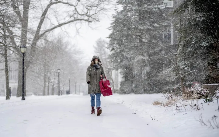 student walking in snow
