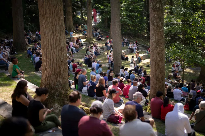 Students and parents sit in outdoor amphitheater