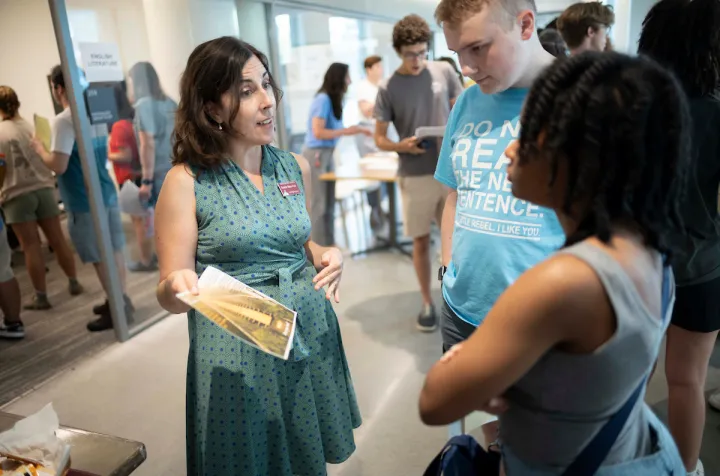 Professor speaks with student during academic advising fair