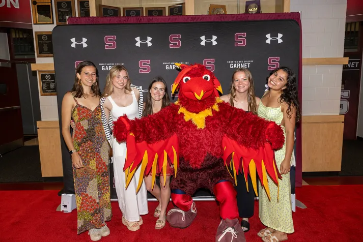 Student-athletes pose with Phineas the Phoenix