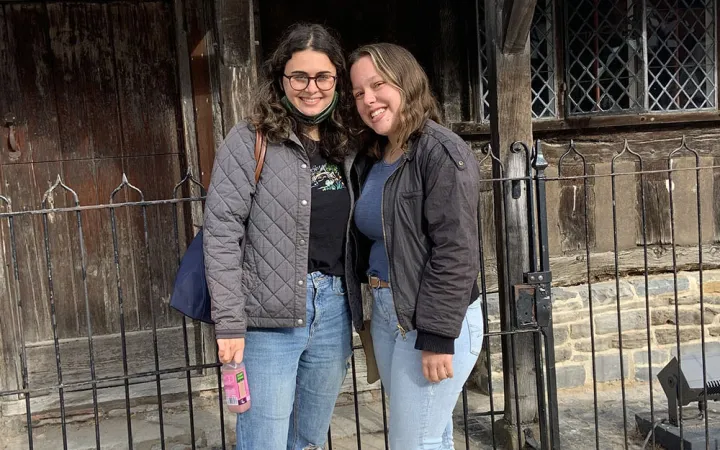2 students in front of a building