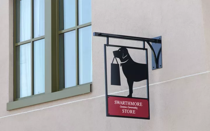 Bookstore sign of dog holding a bag in its mouth