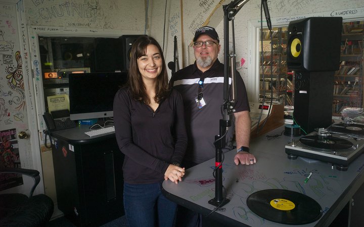 A student and staff member pose inside WSRN radio station