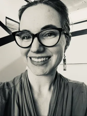 Ellen wearing black glasses.