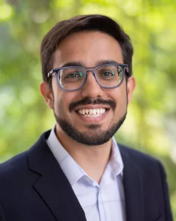 Director of Admissions Isthier Chaudhury smiling, wearing glasses
