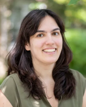 picture of a person with long dark brown hair, brown eyes and green shirt