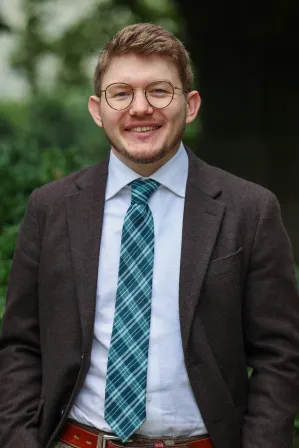 Man with glasses smiling