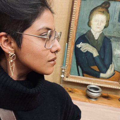 Sabeen Ahmed looking at art