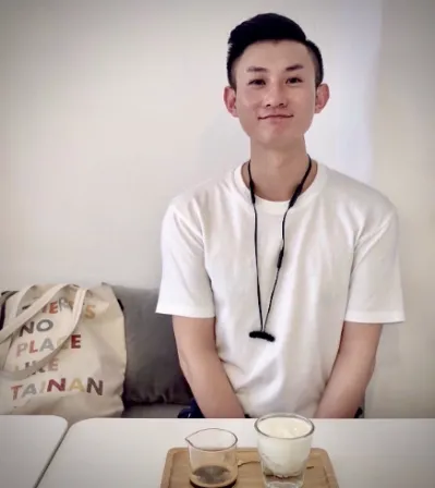 Photo of professor Yuan Gao sitting at a table with a tea service