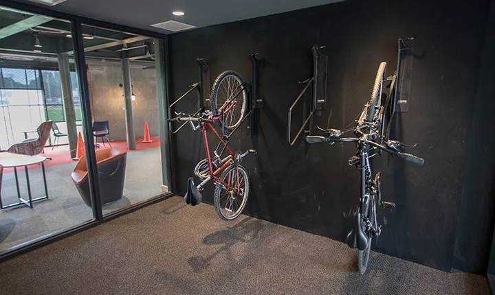 Bicycles hang from the wall on the inside of the building