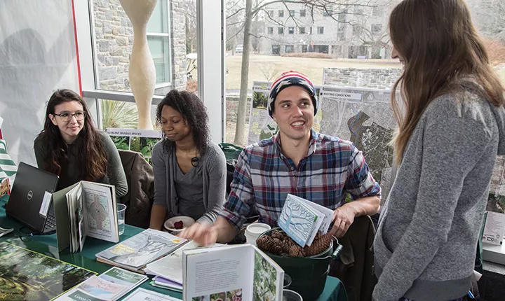 Students at table at sustainability showcase