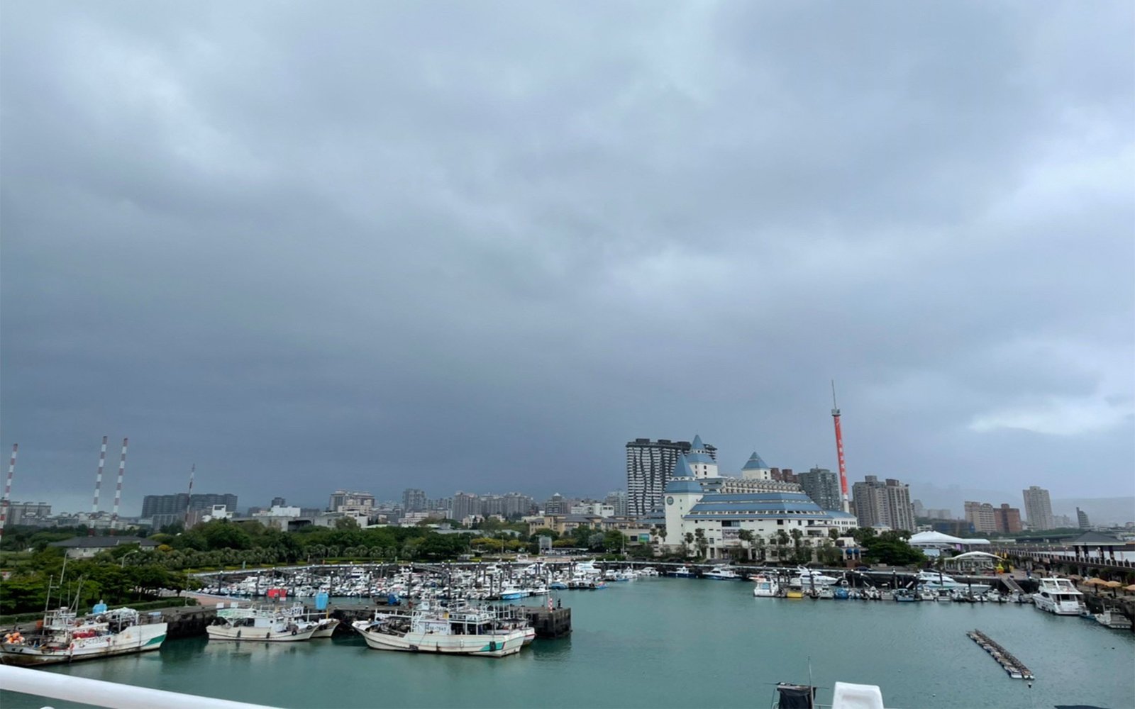 Cloudy sky over city and docked boats
