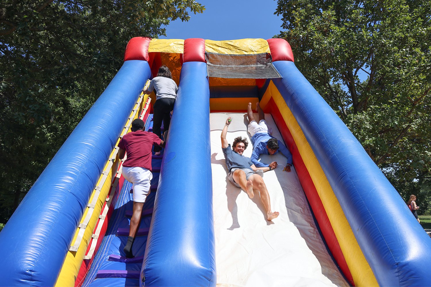 People slide down bouncy obstacle course