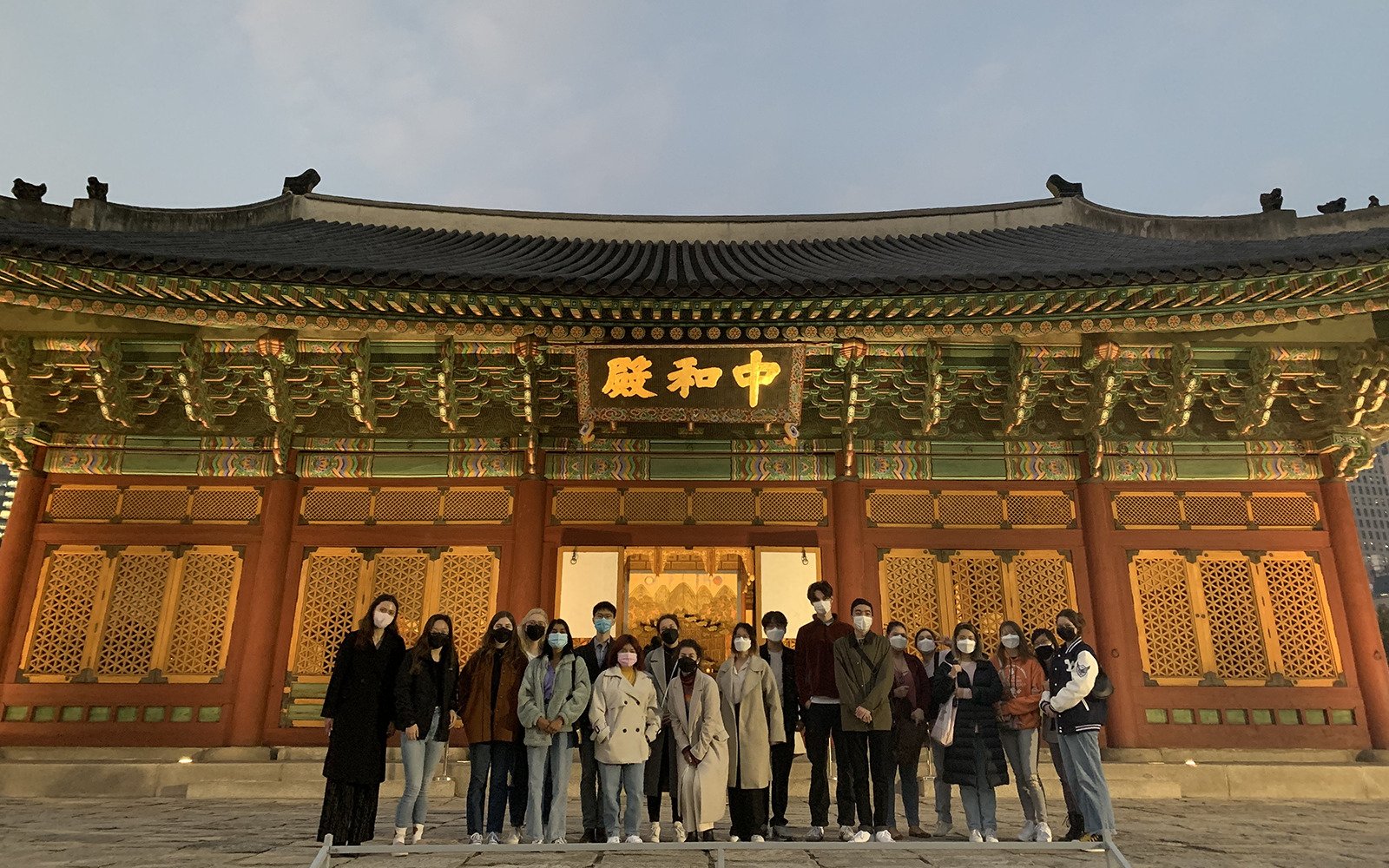 group of students in front of a temple
