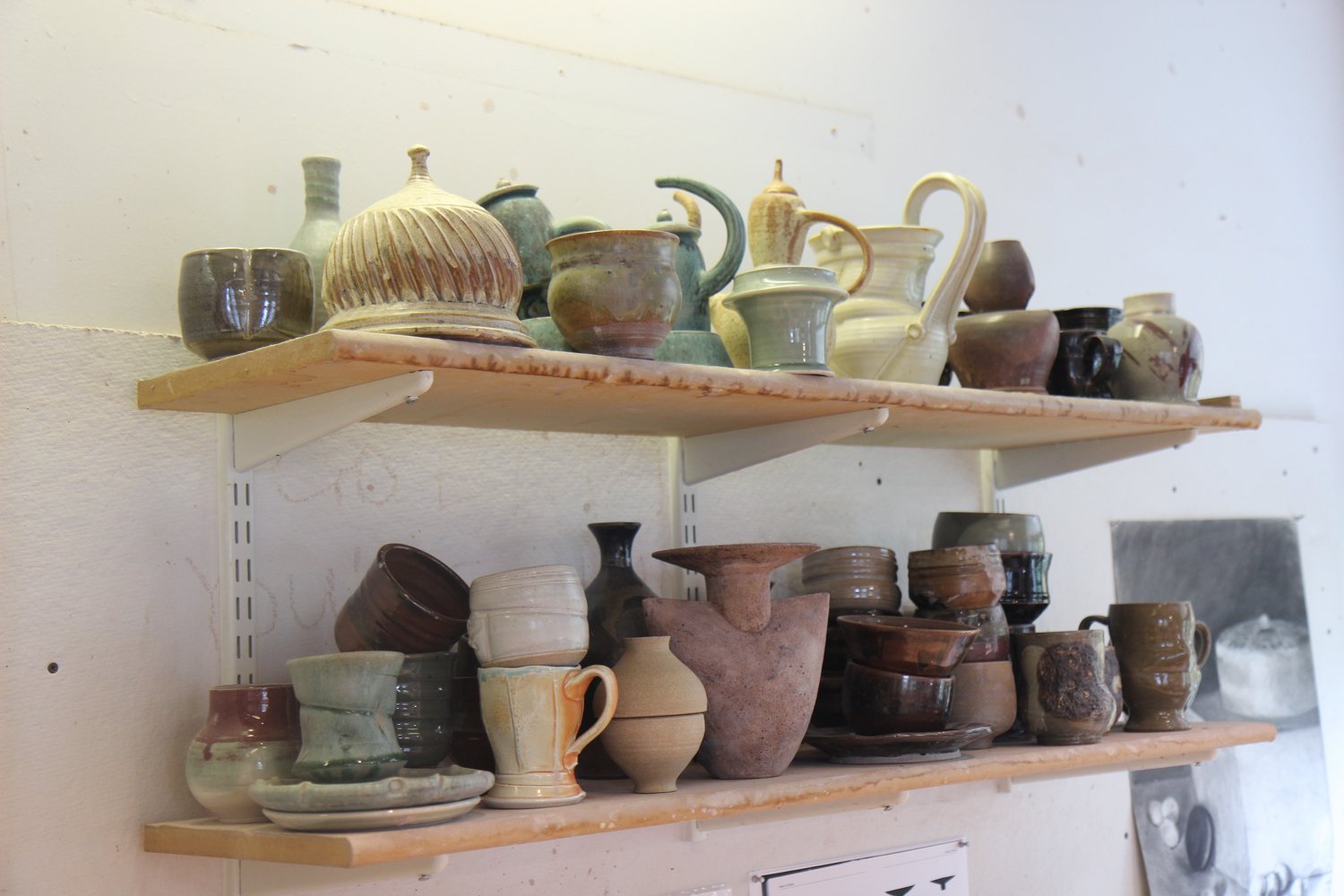 Ceramics, student work lying on shelves inside Beardsley Hall.