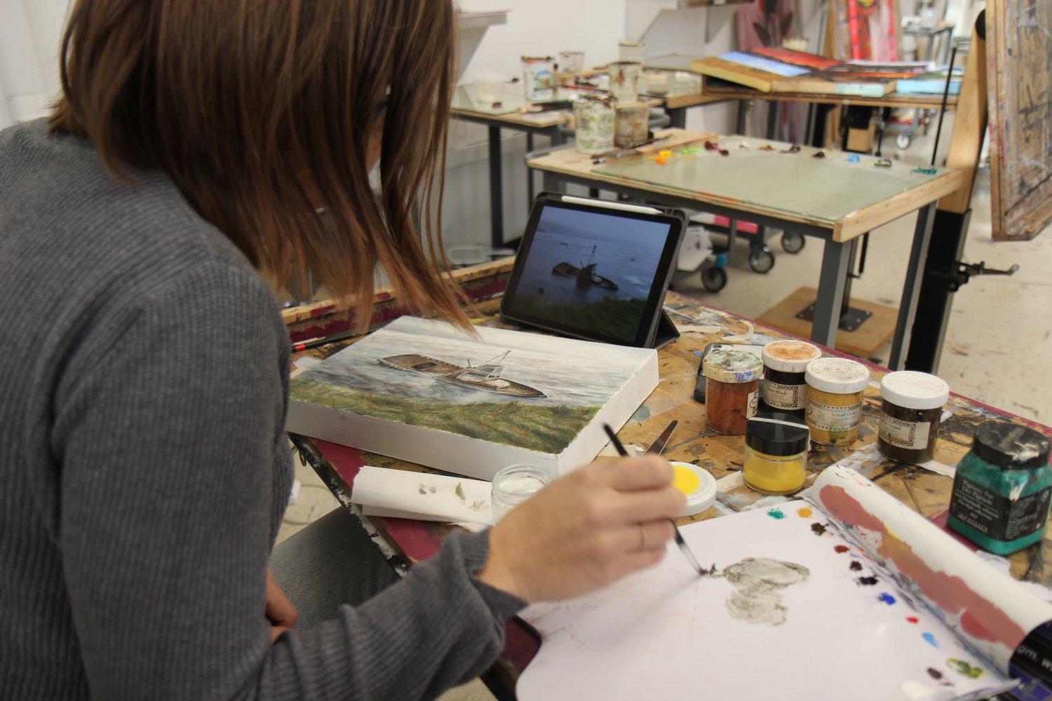 Painting III course. Student paints a landscape using egg tempera the class created.